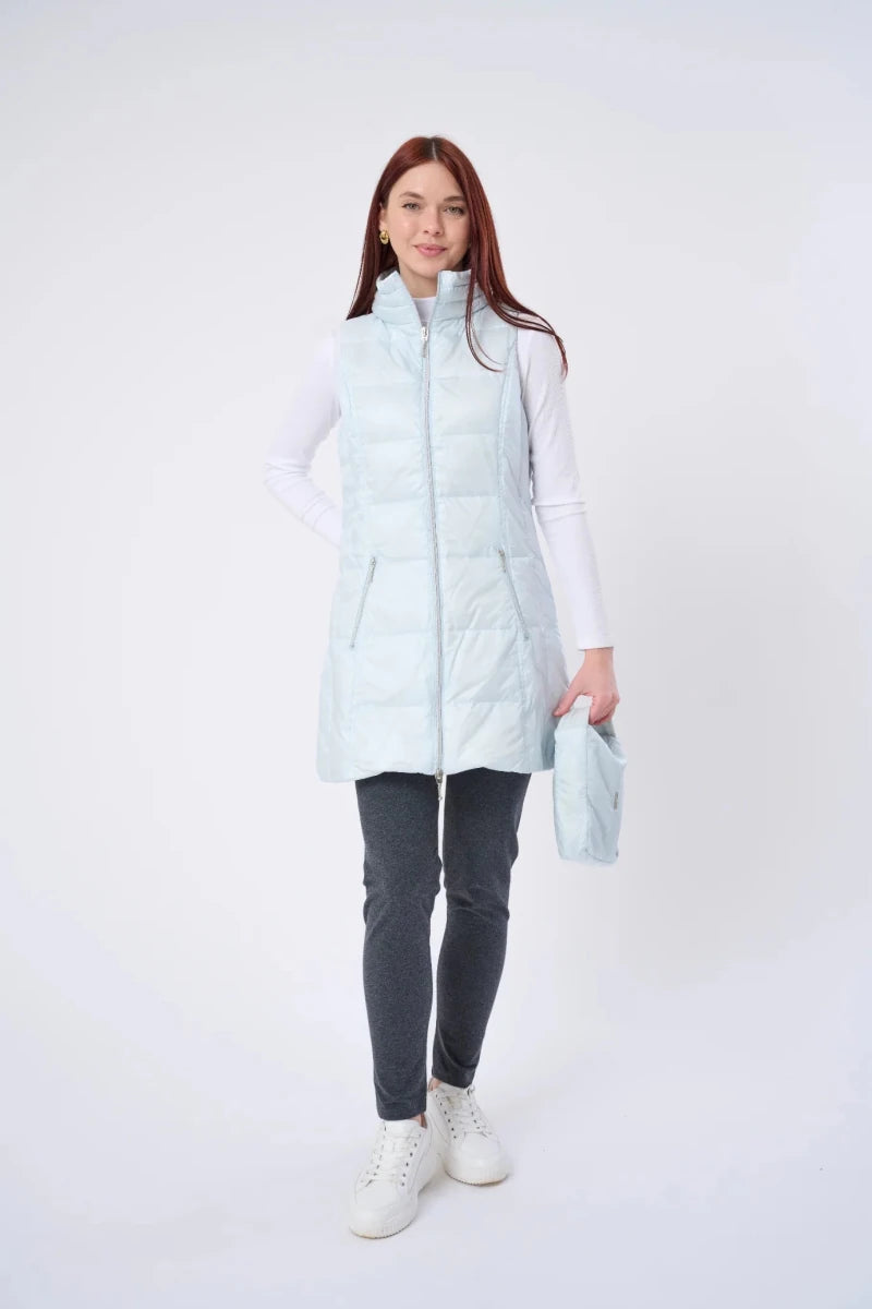 Person wearing a light blue puffer vest over a white shirt on a white background