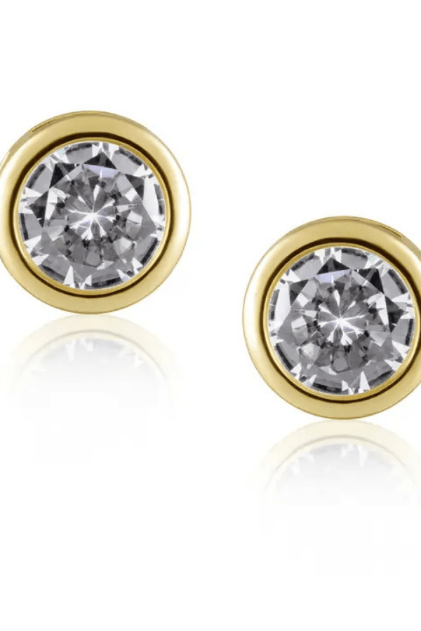 Gold earrings with clear gemstones on a white background