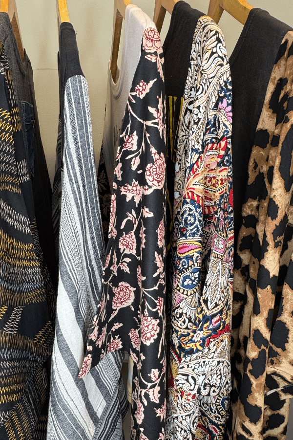 Collection of patterned tops hanging on a rack