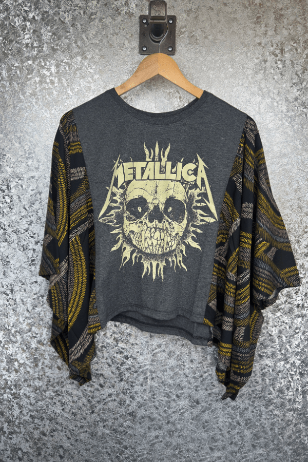 Gray sweater with Metallica graphic on a textured gray background