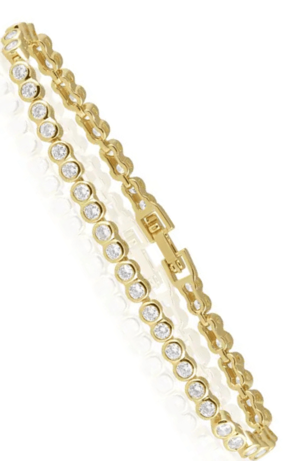 Gold bracelet with clear stones on a white background