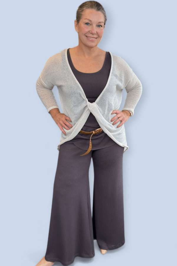 Flowy pant set with white sweater top and belt.