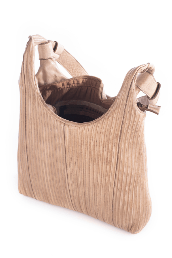 Beige handbag with ribbed texture on a white background