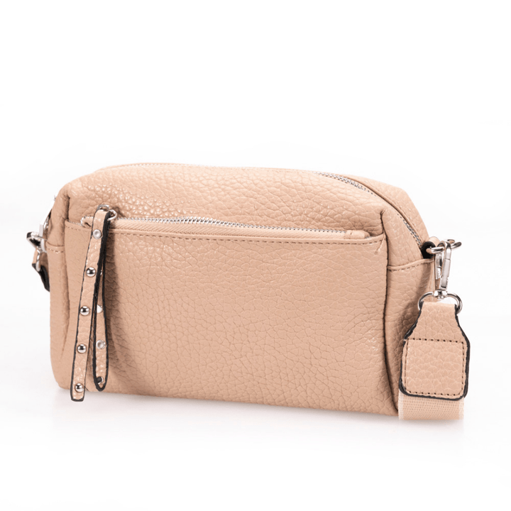 Beige pebbled leather bag on white background.