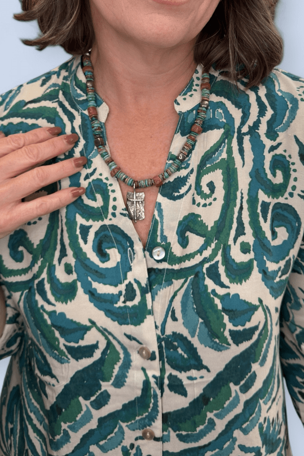 Close view of green printed dress.