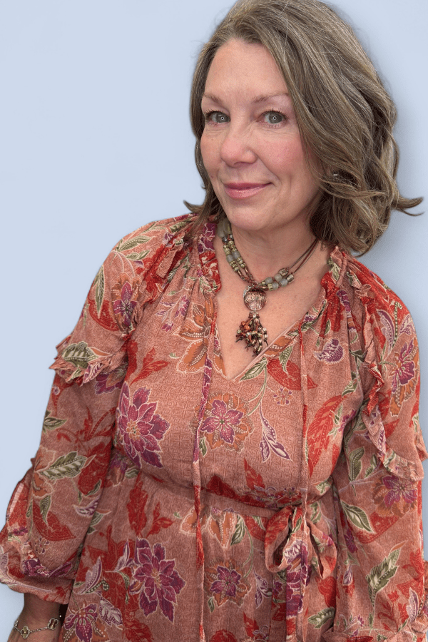 Woman wearing a floral dress with a plain background