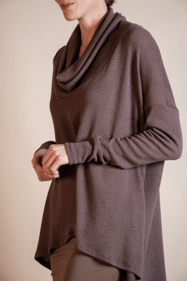 Brown cowl-neck sweater worn by a person on a beige background