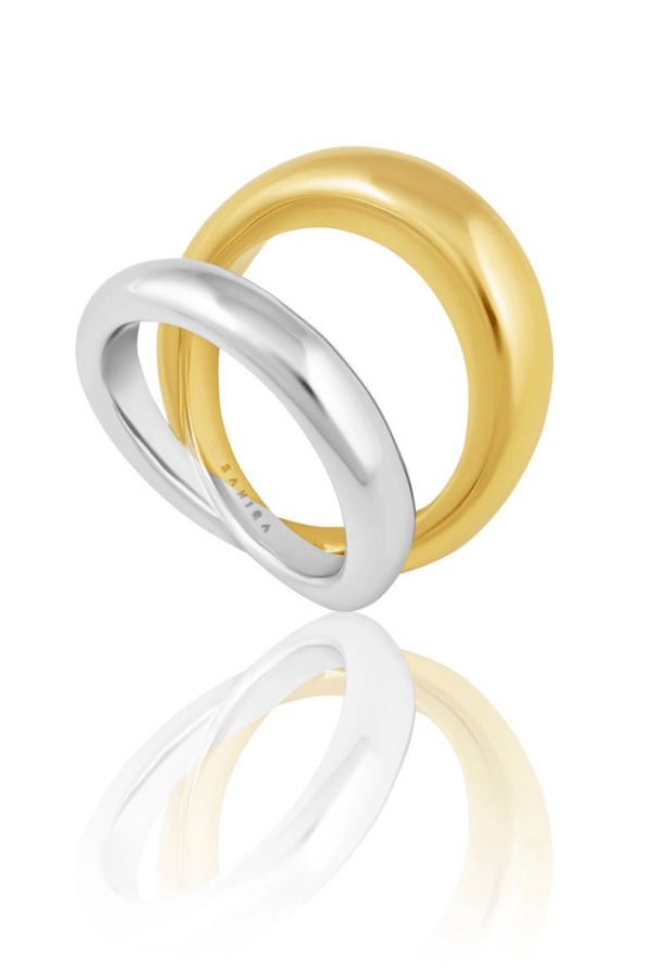 Two rings, one gold and one silver, on a white background