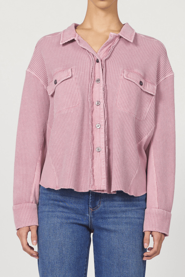 Pink checkered shirt worn by a person on a white background