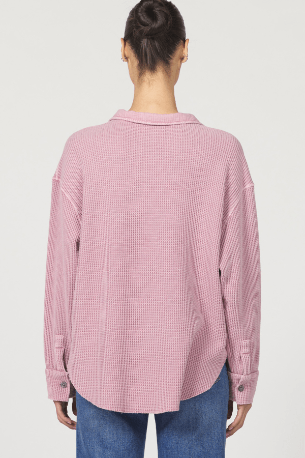 Person wearing a pink checkered shirt on a white background