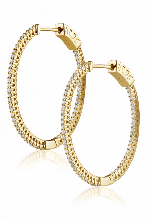 Gold hoop earrings with embedded stones on a white background