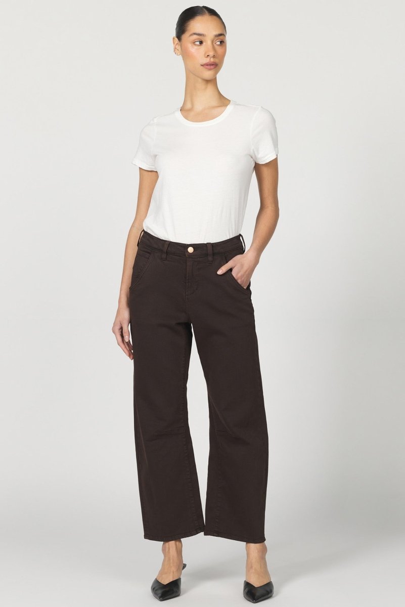 Woman wearing a white t-shirt and brown pants on a white background