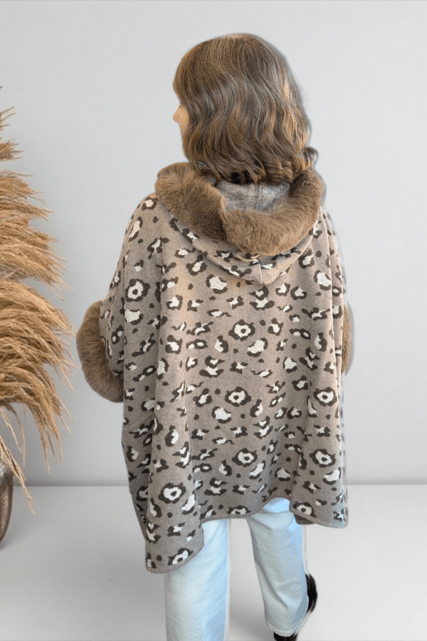 Back view of hooded leopard print cape showing relaxed drape and hem.