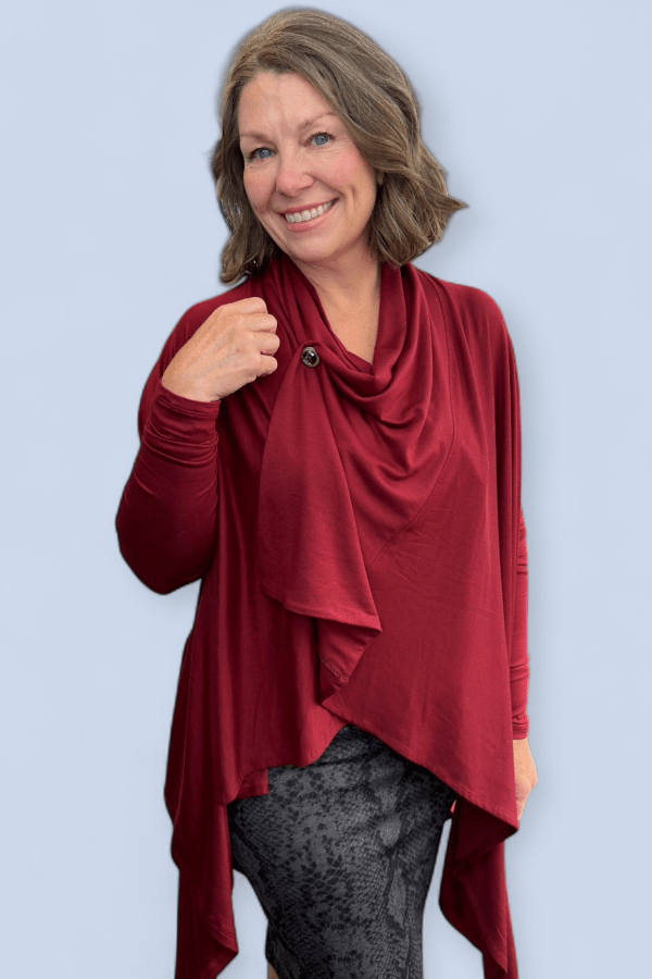 Woman wearing a red scarf and top against a light blue background