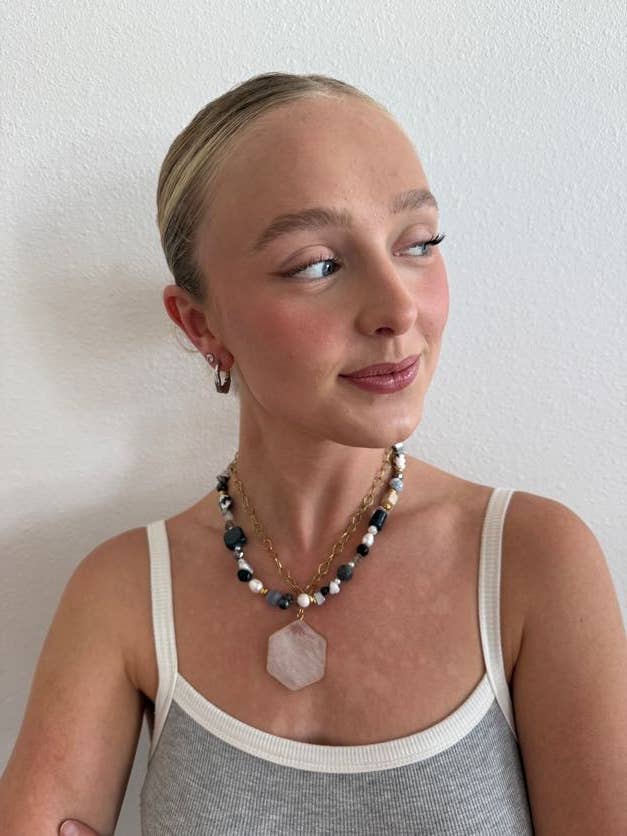Woman wearing a necklace with a white background