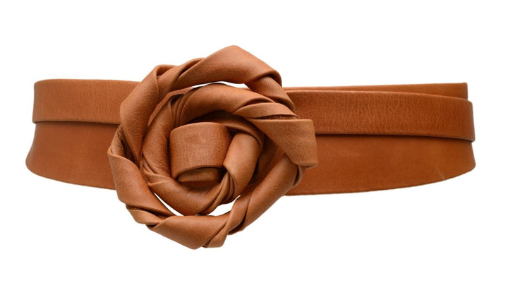 Brown belt with a large flower-like buckle on a white background