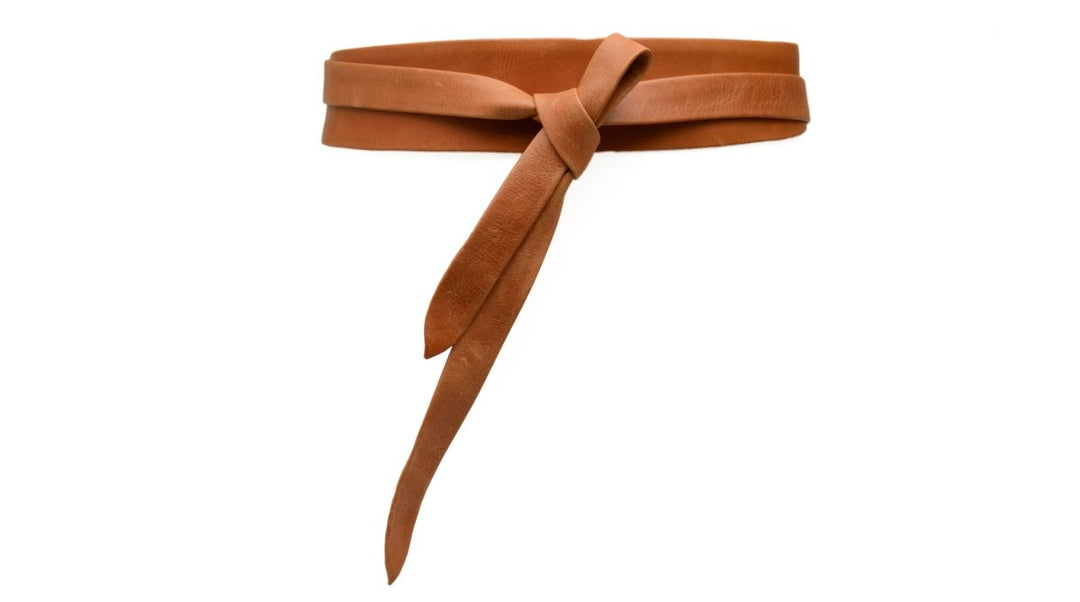 Brown suede belt with a bow on a white background