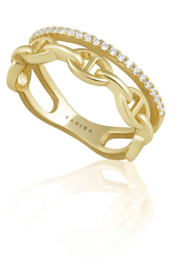 Gold ring with diamond accents on a white background