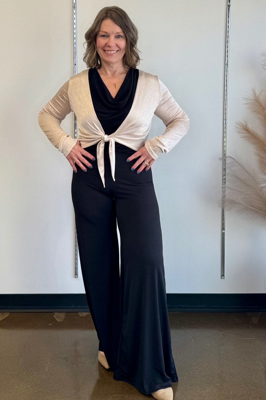 Woman modeling an outfit standing against a white background.