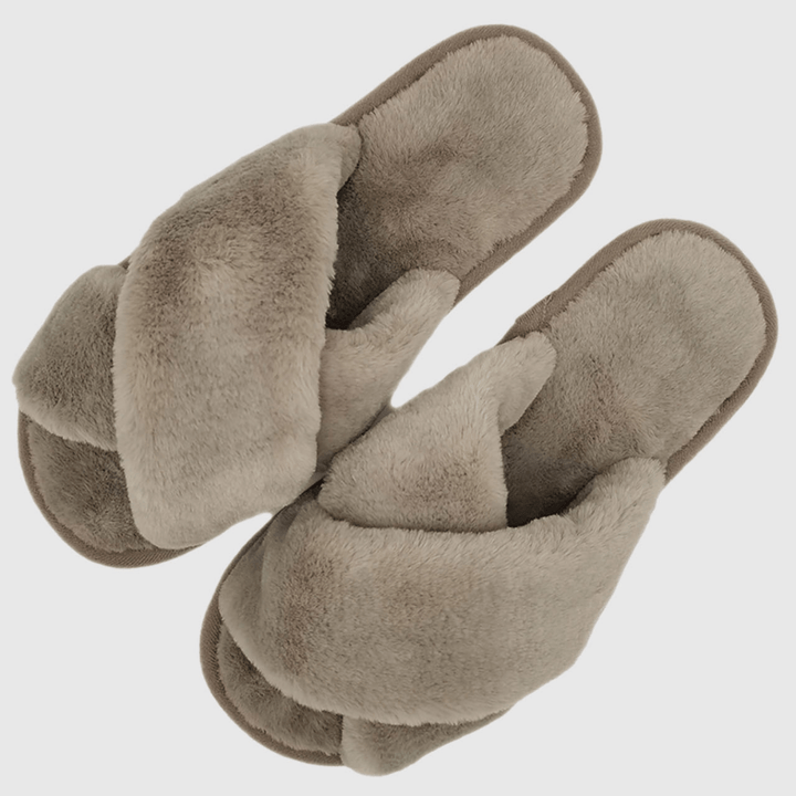 Taupe plush slippers on a white background.