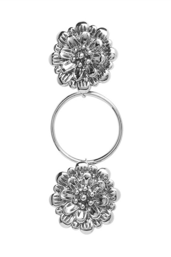 Silver floral fashion fastener on a white background