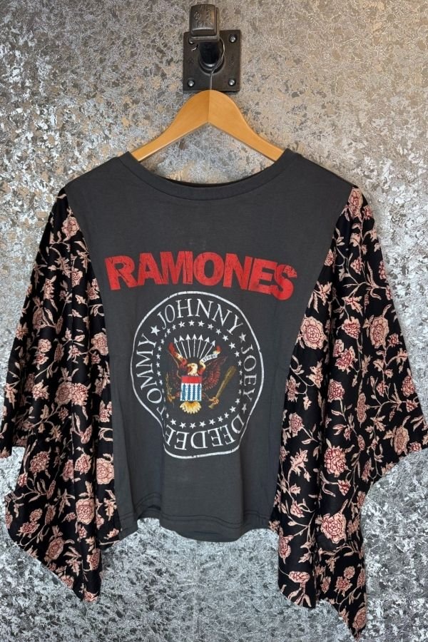 Black t-shirt with 'RAMONES' logo on a hanger with floral cardigan