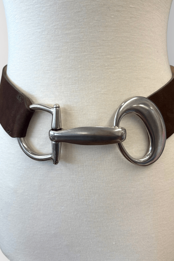 Brown leather belt with a silver buckle on a mannequin.