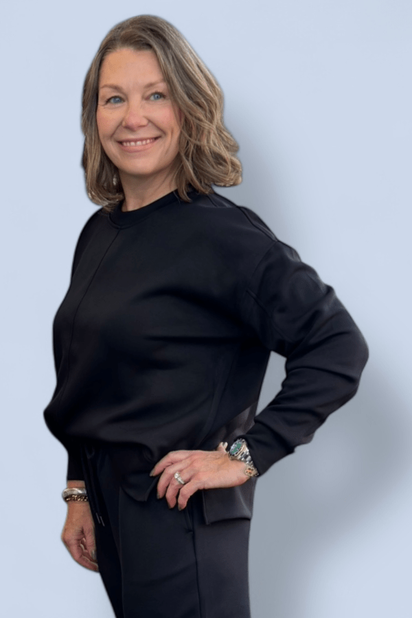 Woman wearing a black outfit against a light blue background