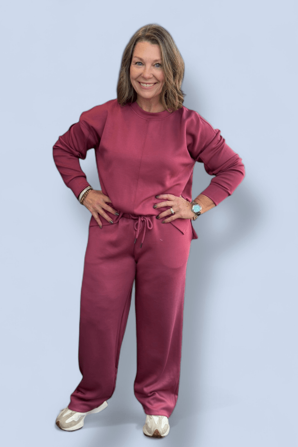 Woman wearing a pink outfit against a light blue background