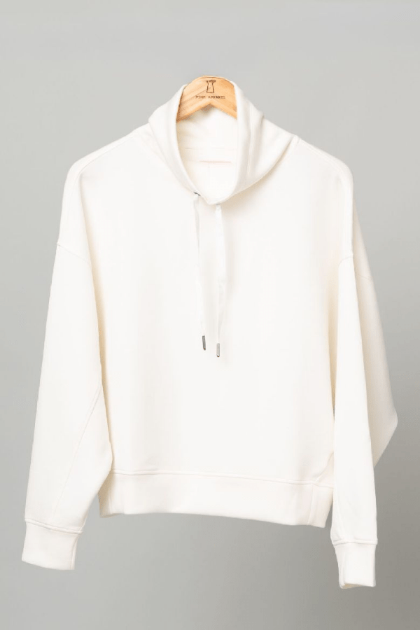 Ivory top hanging on a wood hanger.