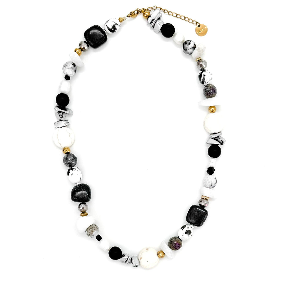 Necklace with black, white, and gold beads on a white background