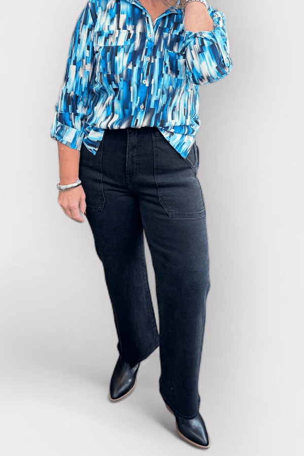 Woman modeling clothes standing in front of a white background.