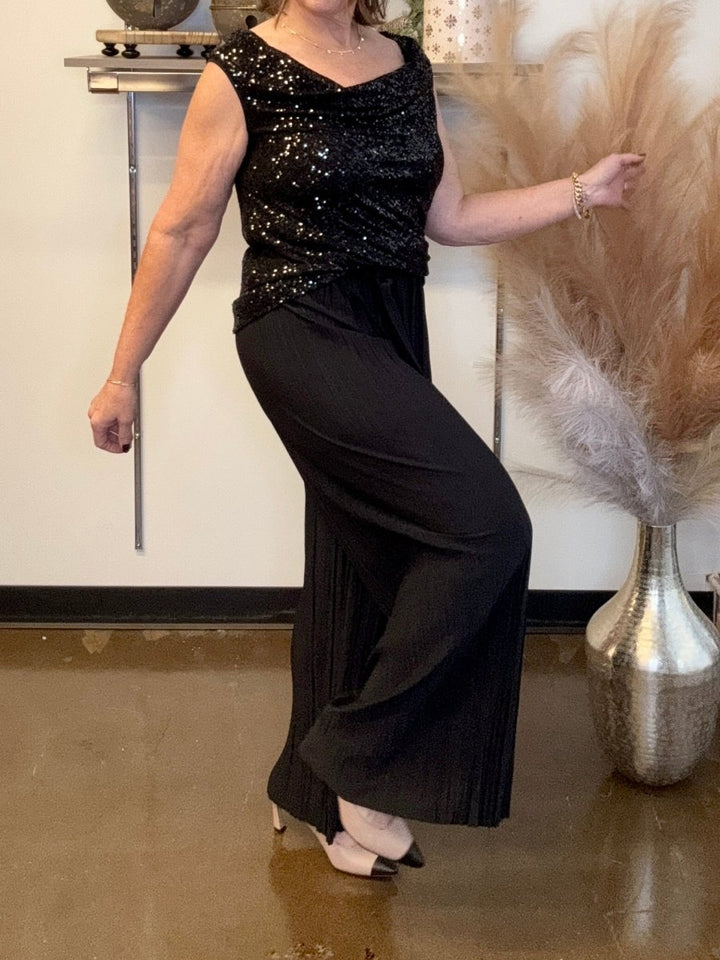 Tie Front Crepe Palazzo Pants in Black — full body side angle view showing flowy wide leg drape, styled with black sequin top and heels
