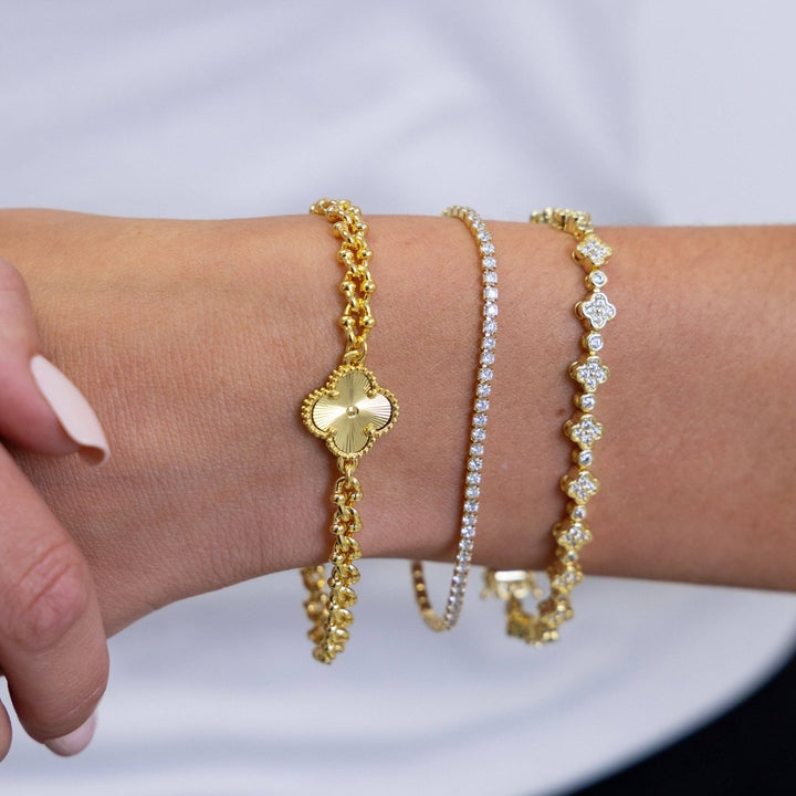 Annie Dainty Tennis Bracelet in Gold — close-up stacked between two clover bracelets