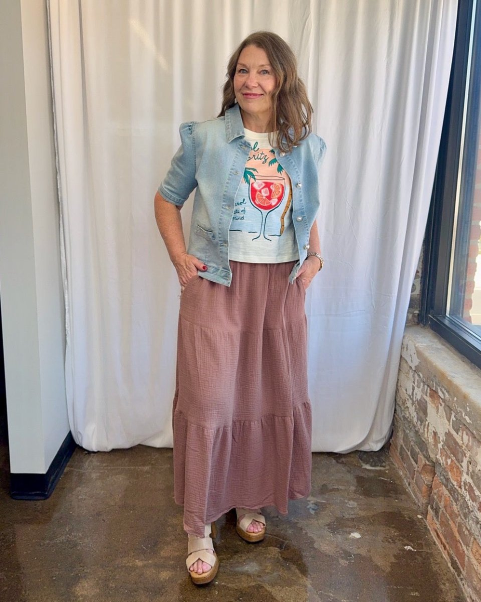 Wildfox Aperol State of Mind Nova Tee in Snow White with hands on hips under light wash cropped denim jacket and mauve tiered maxi skirt, front view on model
