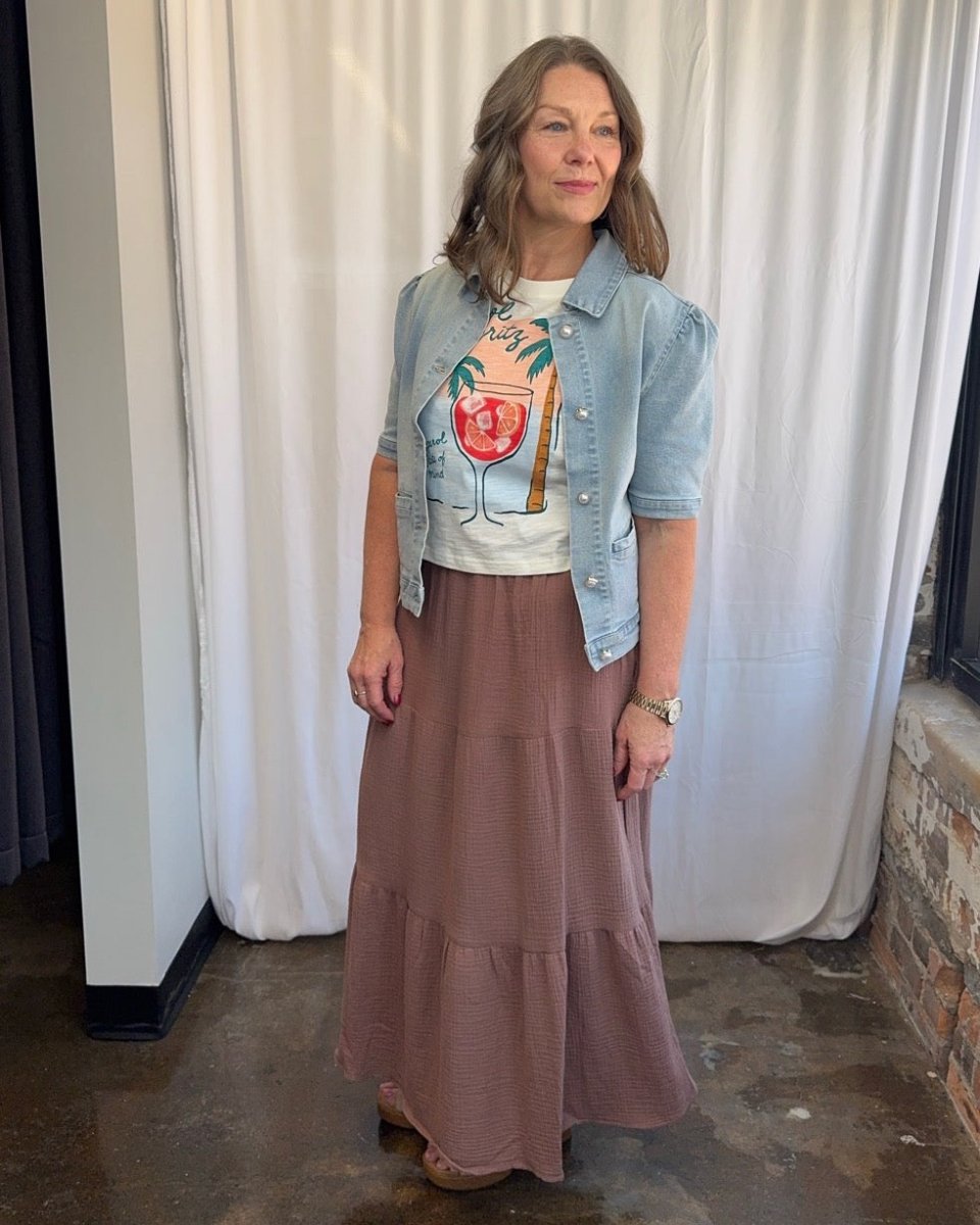 Wildfox Aperol State of Mind Nova Tee in Snow White under open cropped denim jacket with dusty rose maxi skirt and wedge sandals, model looking right, front view
