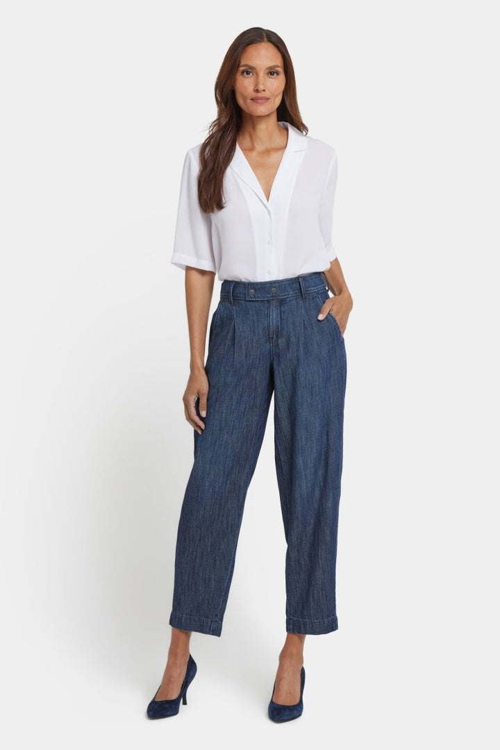 Balloon Trouser Jeans With Pleats in La Mer — full outfit with white blouse and pointed-toe pumps