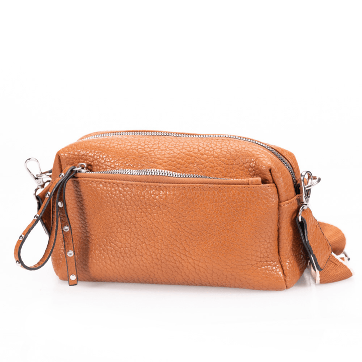 Camel pebbled leather bag on white background.