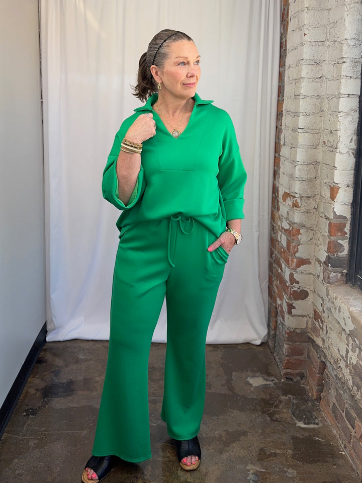 Carole Christian Scuba Modal Split-Collar Wide-Leg Set in Kelly Green, full-length front view of complete monochromatic two-piece set on model