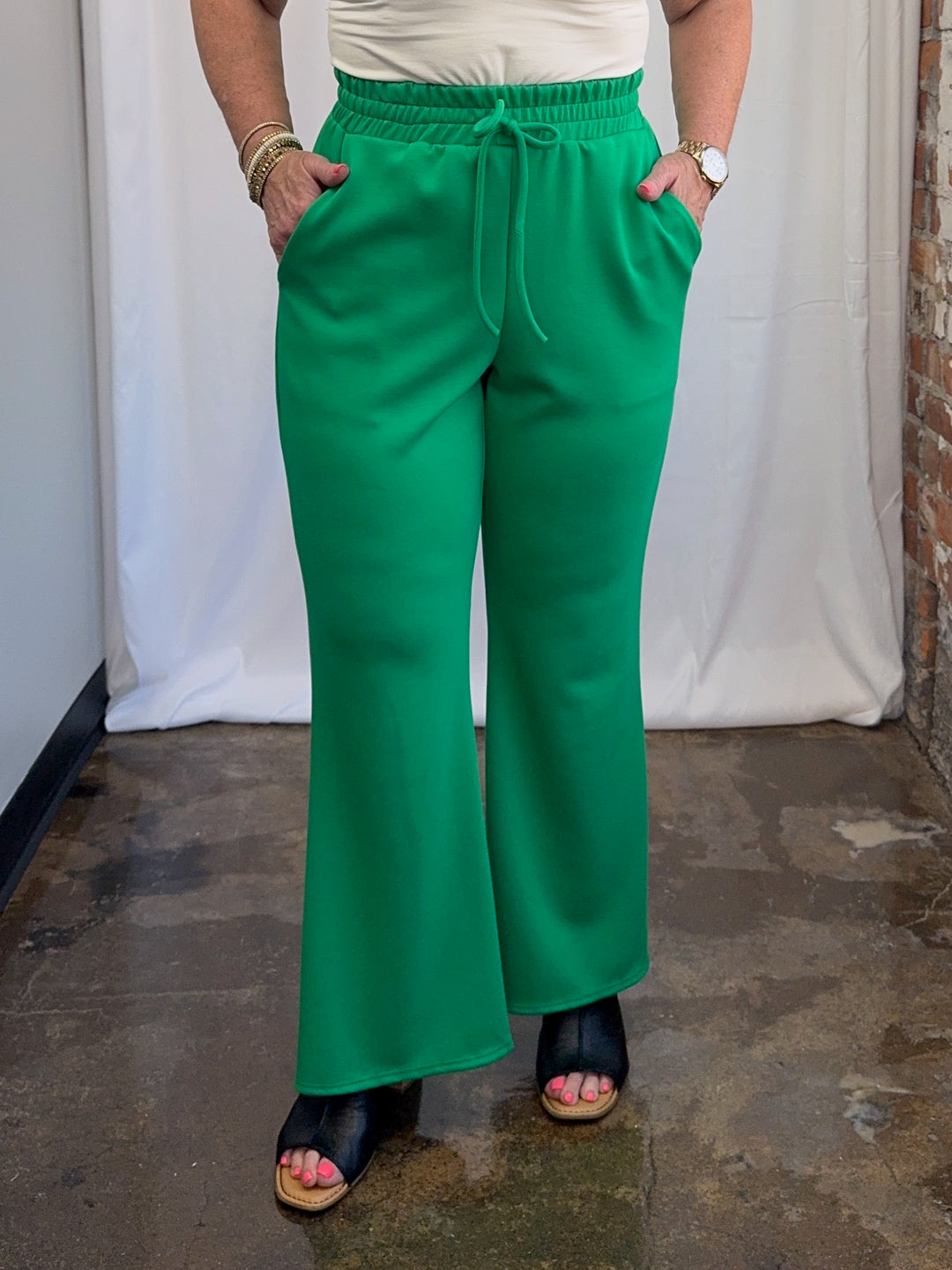 Carole Christian Scuba Modal Split-Collar Wide-Leg Set in Kelly Green, front view of wide-leg pant with elastic drawstring waistband and side pockets on model