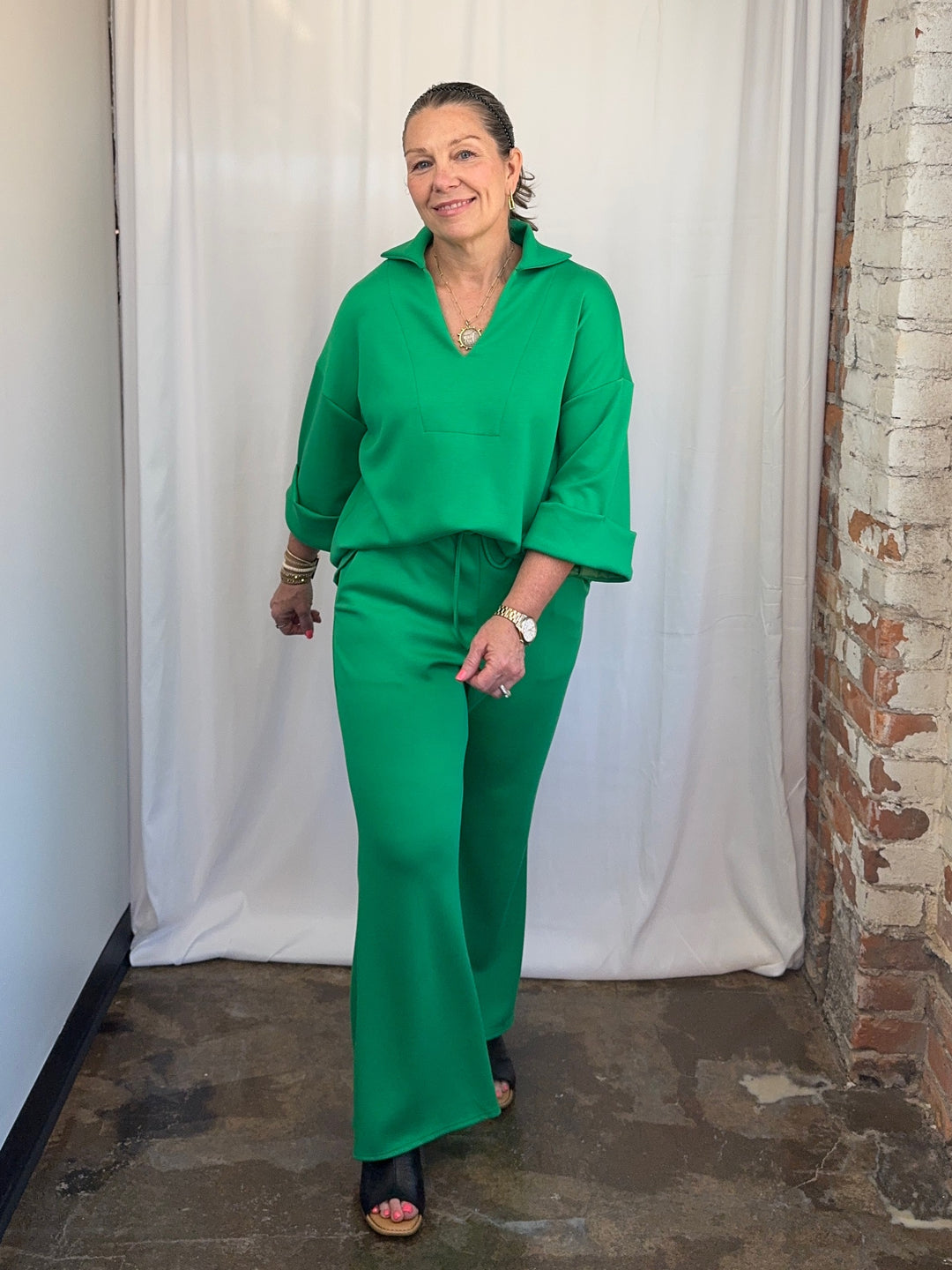 Carole Christian Scuba Modal Split-Collar Wide-Leg Set in Kelly Green, full-length front view smiling showing relaxed wide-leg silhouette on model