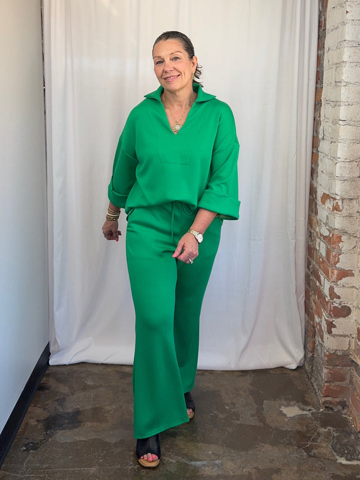 Carole Christian Scuba Modal Split-Collar Wide-Leg Set in Kelly Green, full-length front view smiling showing relaxed wide-leg silhouette on model
