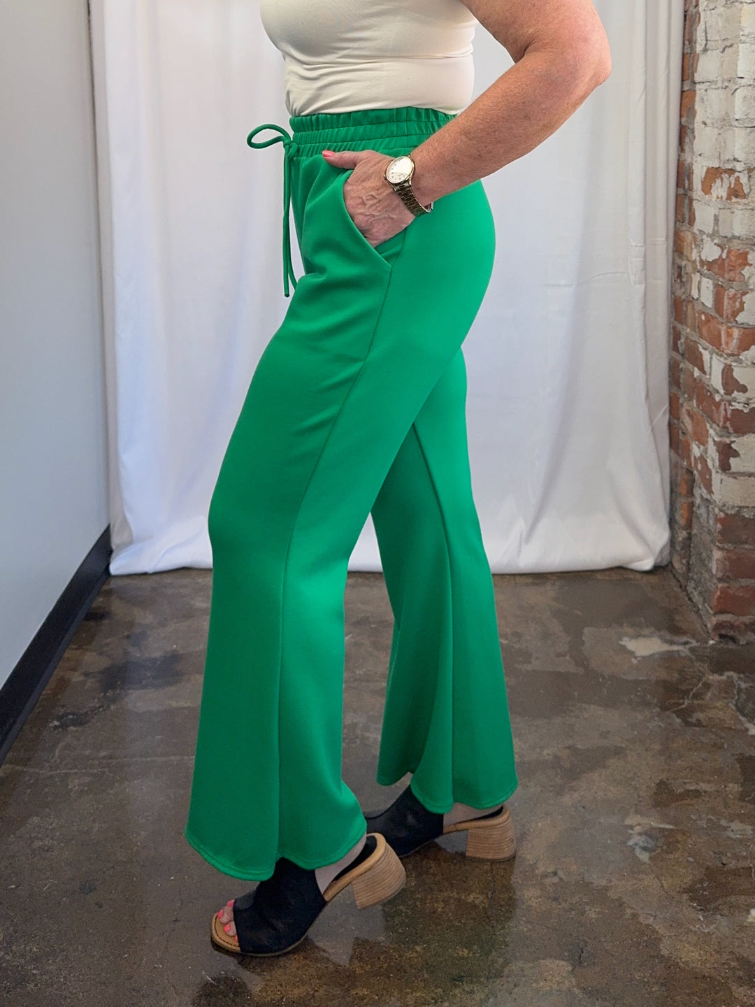 Carole Christian Scuba Modal Split-Collar Wide-Leg Set in Kelly Green, side view showing wide-leg pant drape and drawstring waist on model