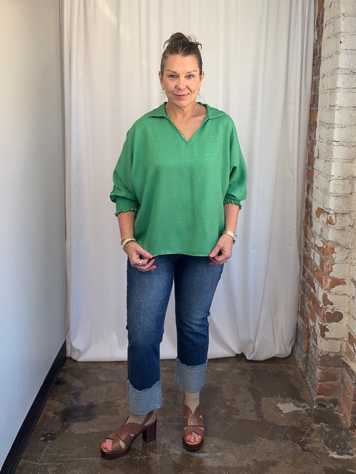 Carole Christian Relaxed Collar V-Neck Smocked Sleeve Blouse in Kelly Green, relaxed fit styled with straight-leg jeans, full-length front view on model