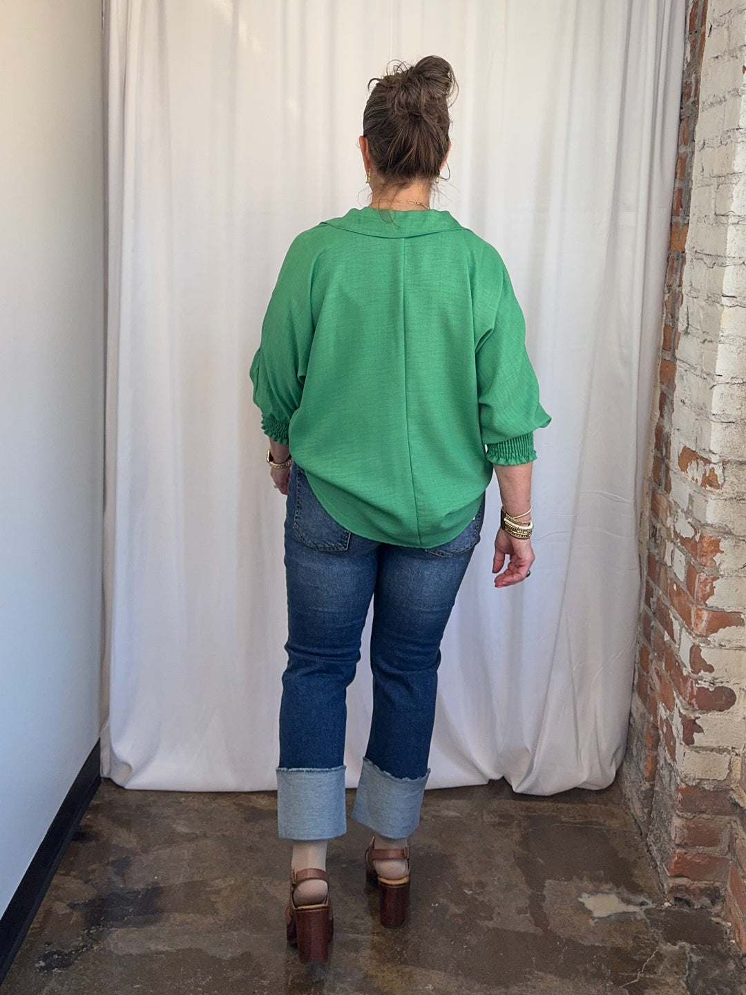 Carole Christian Relaxed Collar V-Neck Smocked Sleeve Blouse in Kelly Green, dolman silhouette and curved hem, rear view on model