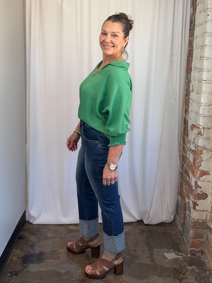Carole Christian Relaxed Collar V-Neck Smocked Sleeve Blouse in Kelly Green, lightweight polyester with curved hem, side view on model