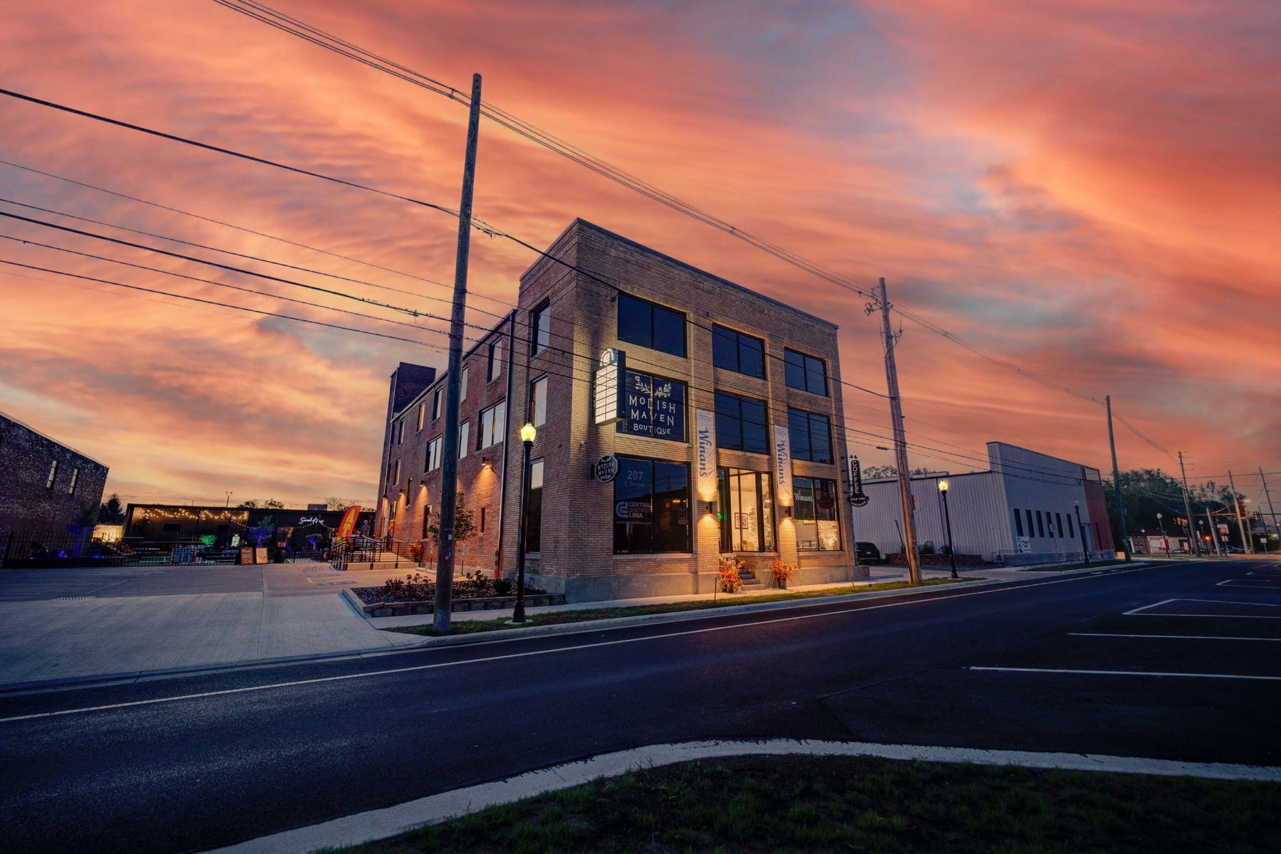 Building at dusk with a colorful sky that is home to Modish Maven Boutique.