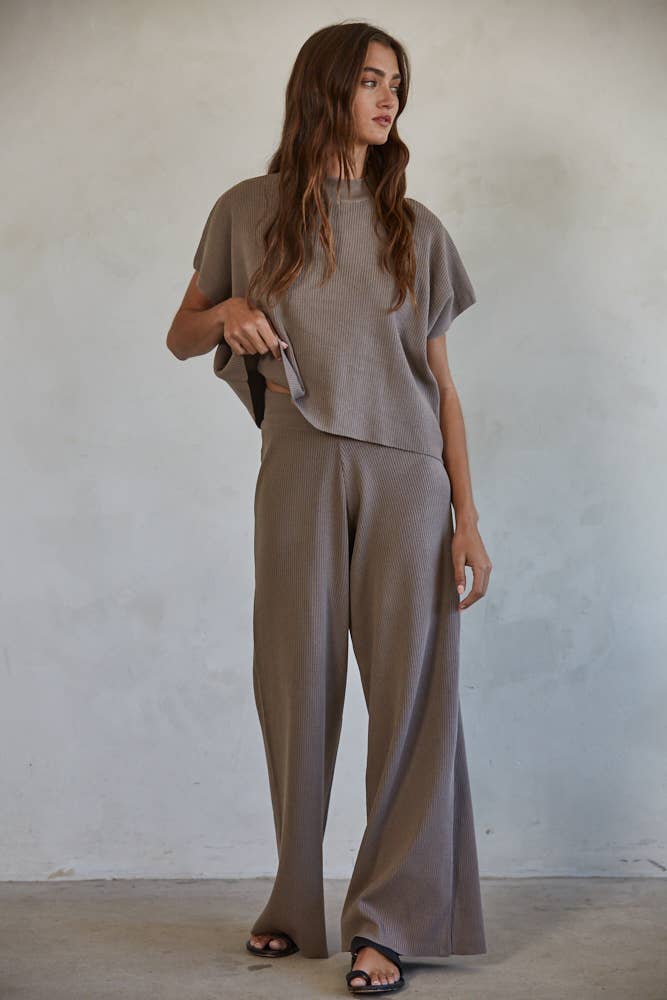 A pair of brown high-waisted wide leg pants with ribbed detailing, showing the outfit view.