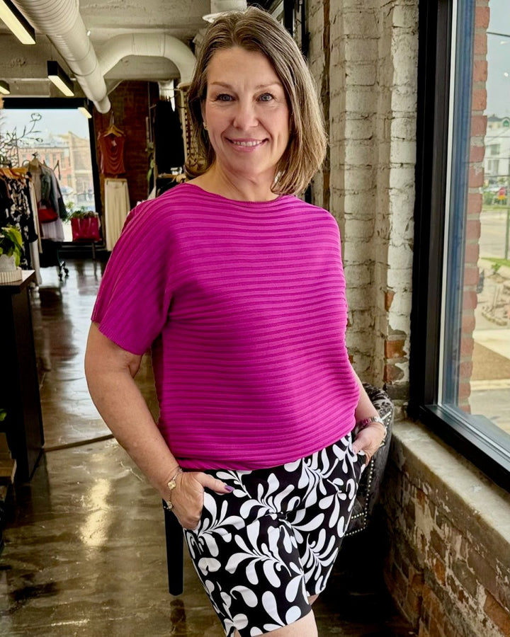 Carrigan magenta ribbed short sleeve top styled with black and white floral print shorts — women&
