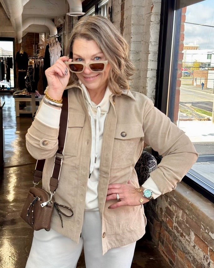 Corduroy Button Front Shacket in Beige, relaxed open-front silhouette with chest pockets layered over a cream hoodie, front view on model
